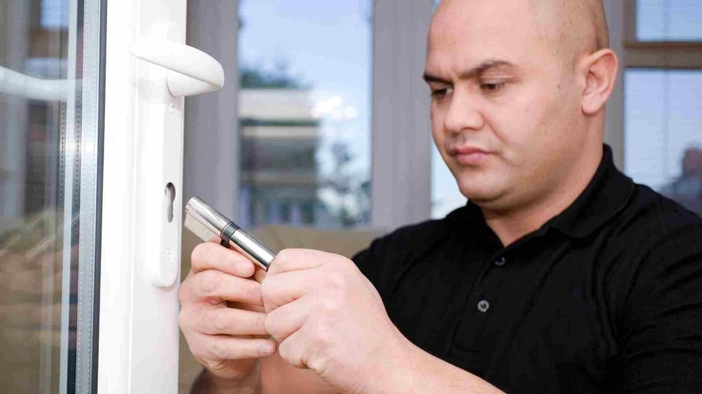 Professional locksmith installing a door lock cylinder